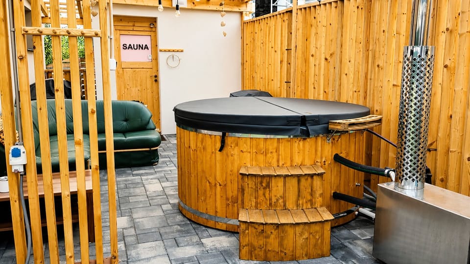 Private sauna and wood-fired hot tub in a cozy outdoor spa retreat