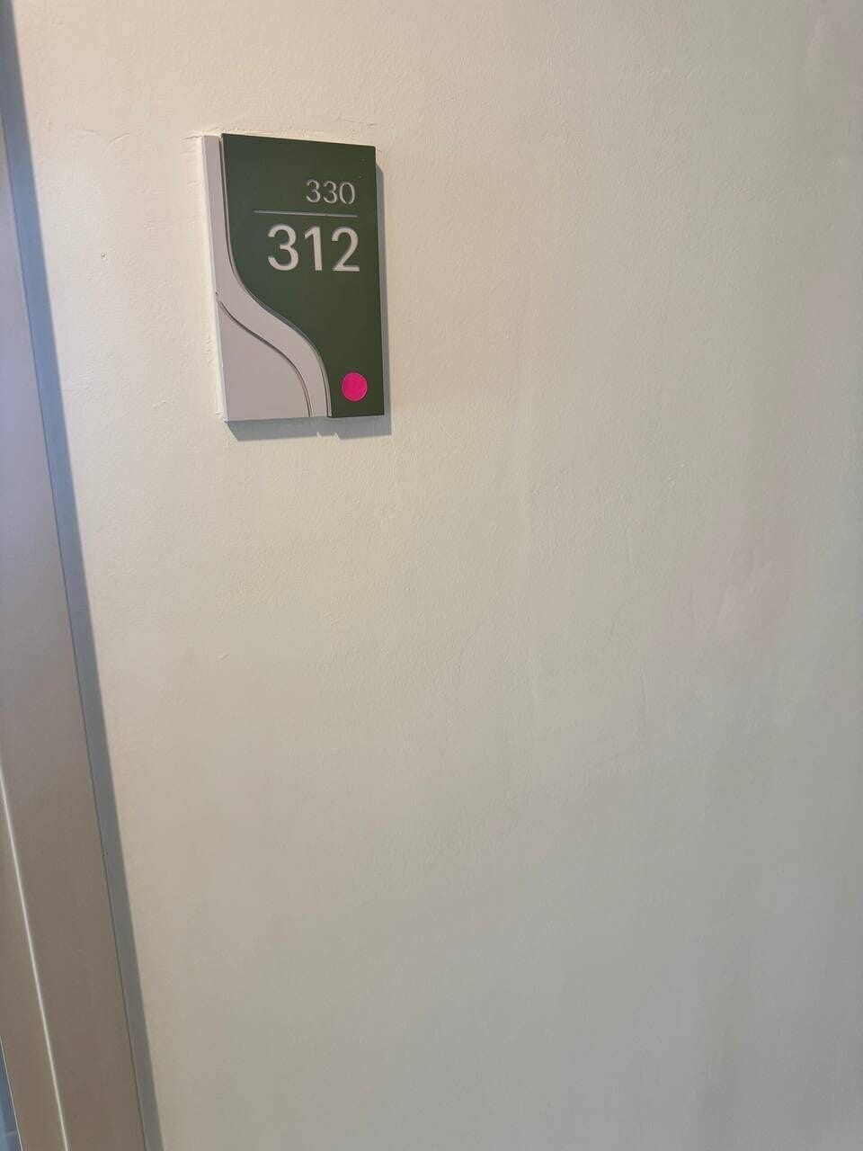 Clearly marked Unit 312 in a clean, well-maintained hallway
