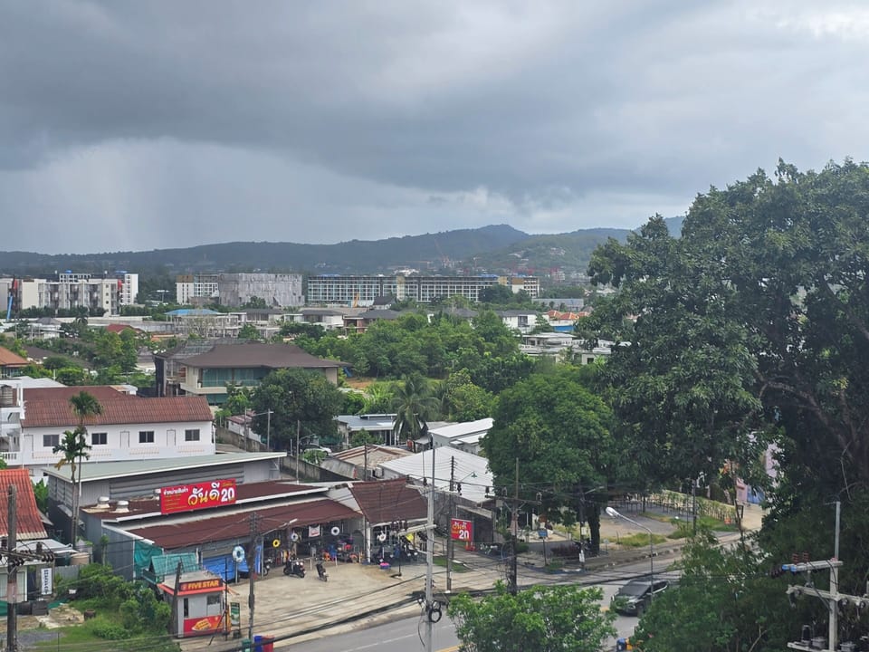 Elevated neighborhood view with lush greenery and rolling hills