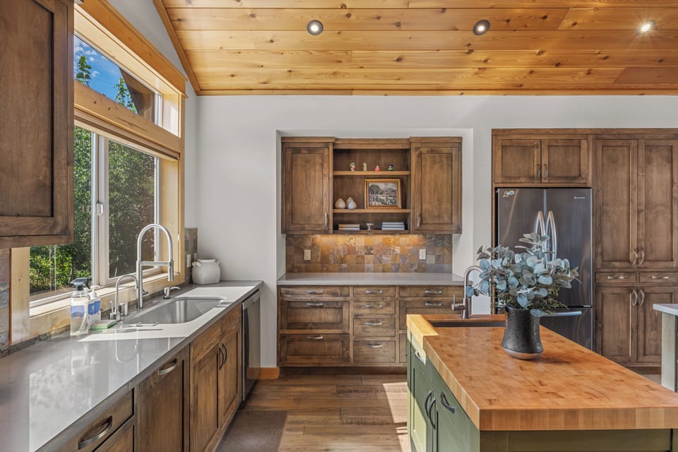Rustic kitchen with warm wood cabinetry and butcher-block island.