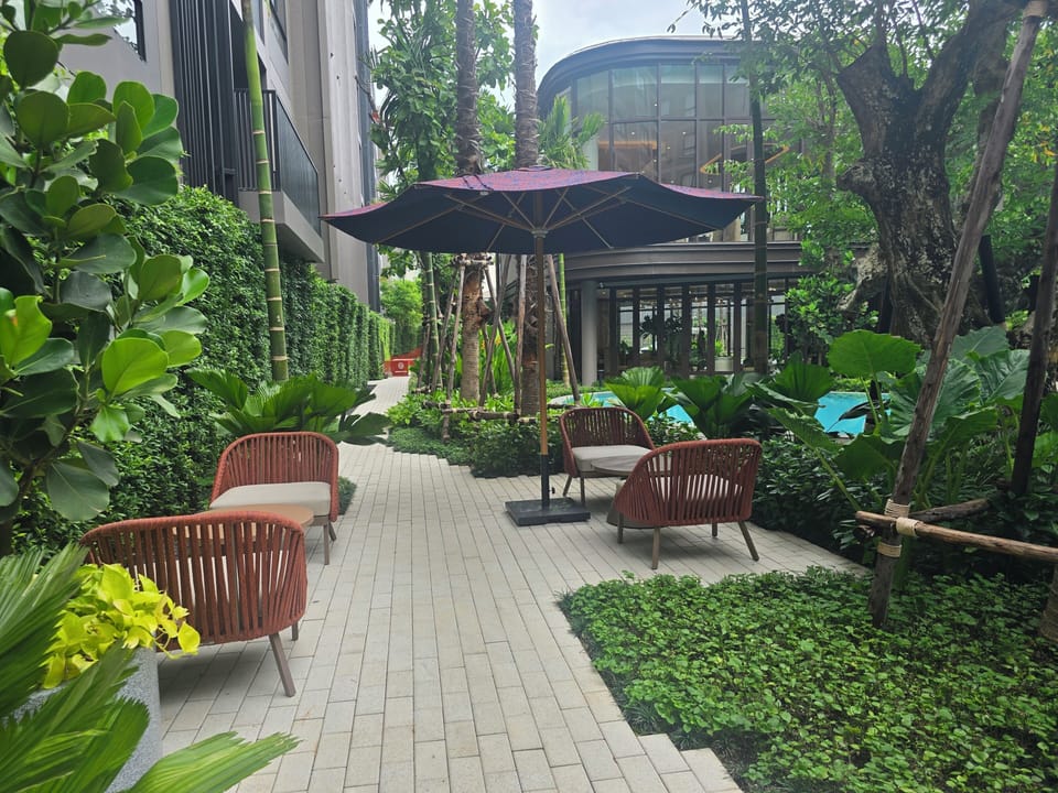 Lush garden courtyard with shaded seating and resort-style ambiance