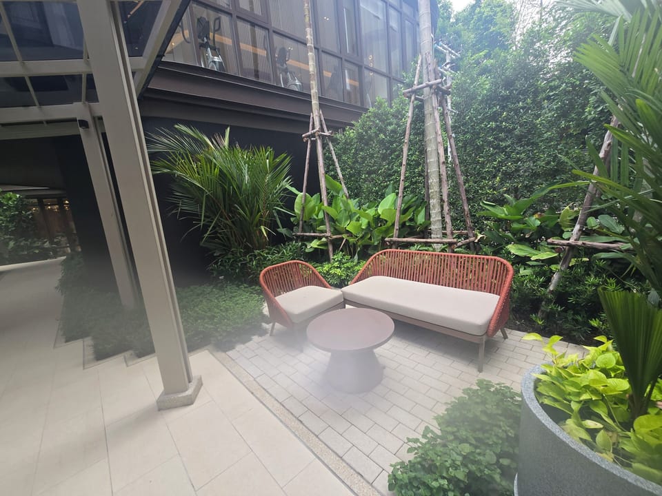 Private garden patio with cozy seating in a lush tropical setting