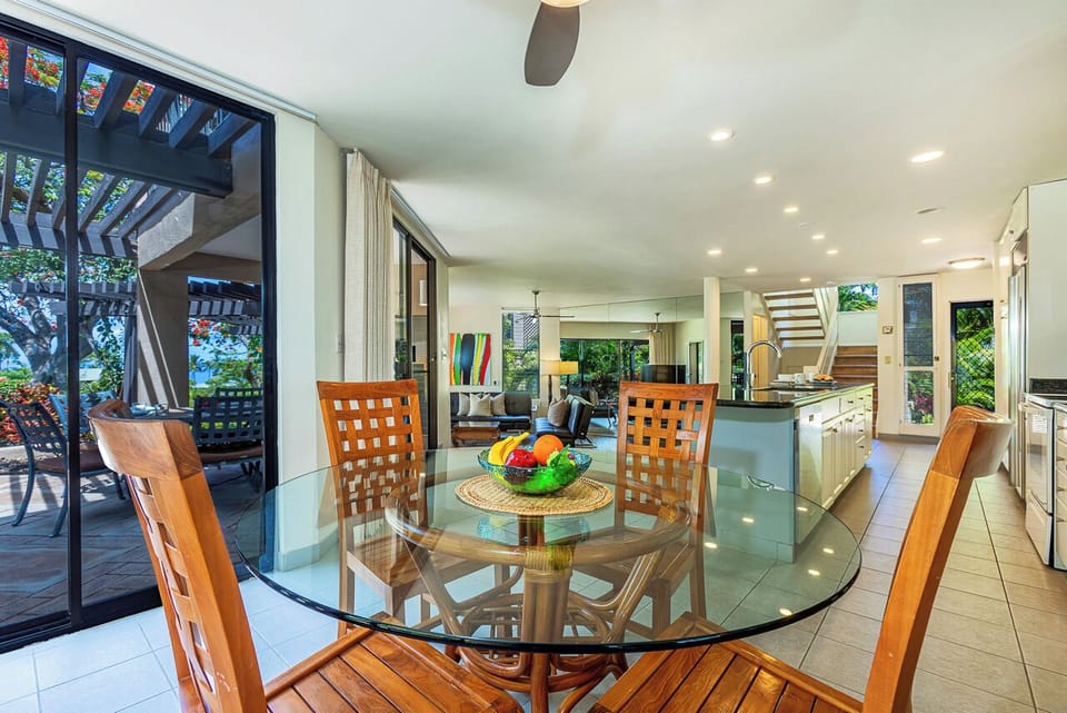 Gather around this inviting dining space with glass doors opening to your private patio. The open layout connects you to the kitchen and living areas, perfect for shared meals and conversation.