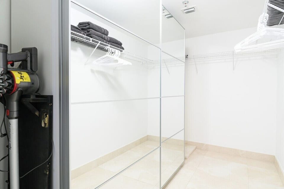 Stay organized with a mirrored closet, wire shelving, and extra storage—great for extended stays.