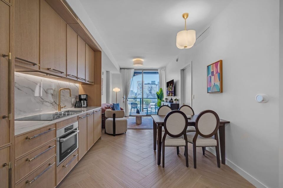 Elegant dining area with designer chairs and warm wood finishes — a sophisticated space to enjoy your meals together