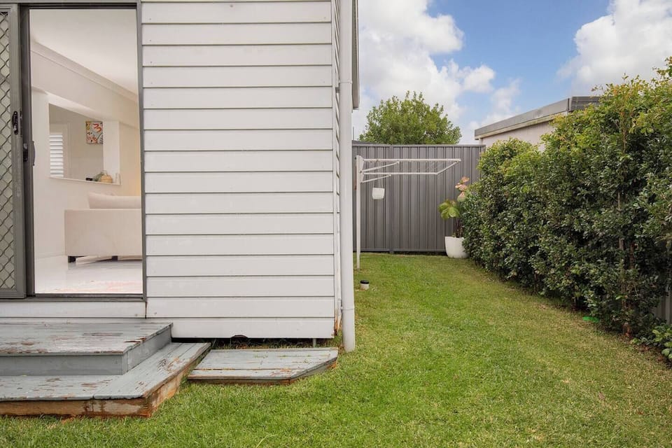 Enjoy the practicality of a private backyard with open lawn space and a clothesline, providing added convenience throughout your stay.