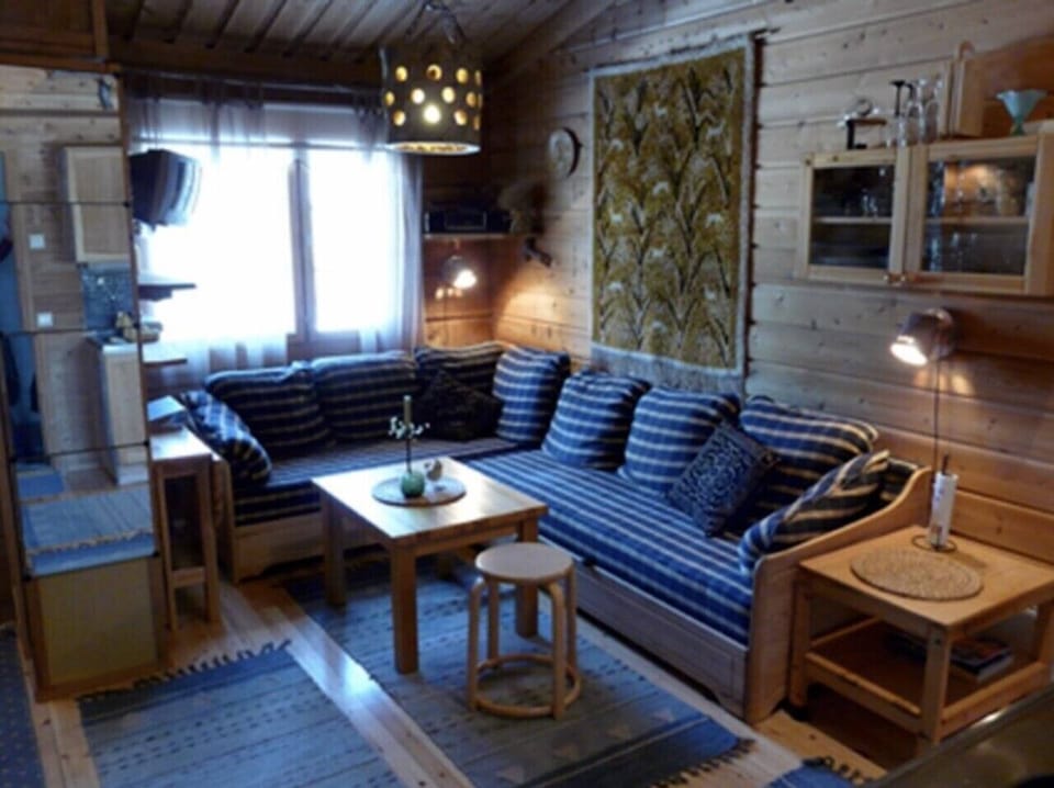 Living room with a large corner sofa and a coffee table by the window.