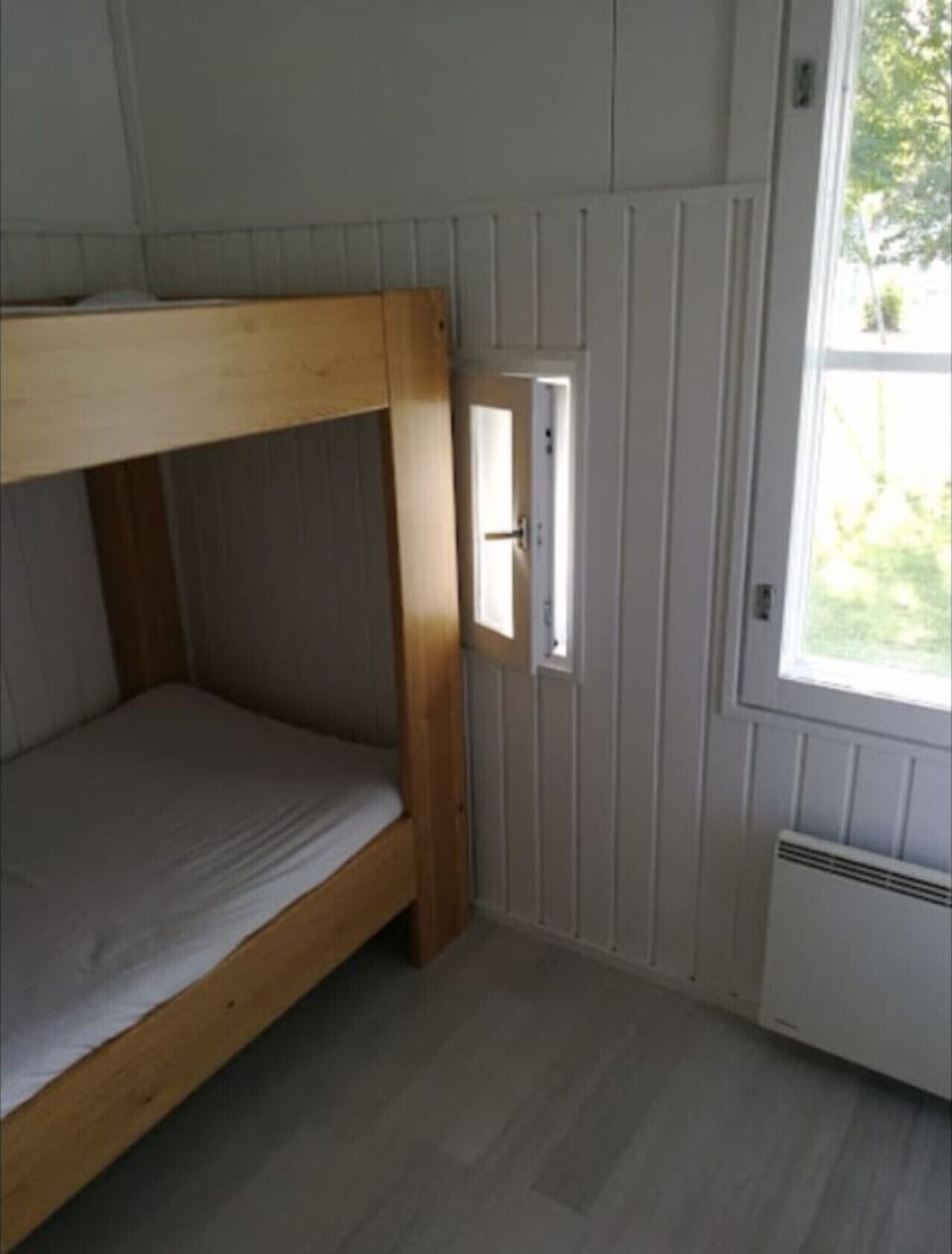 Second bedroom with a bunk bed and a window.