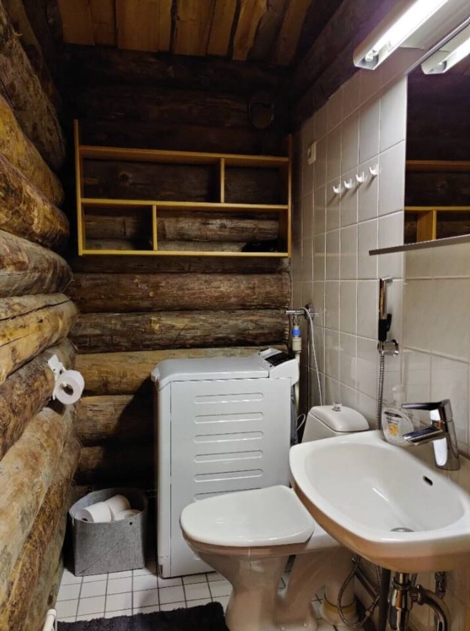 Separate WC with a washbasin, toilet and washing machine.