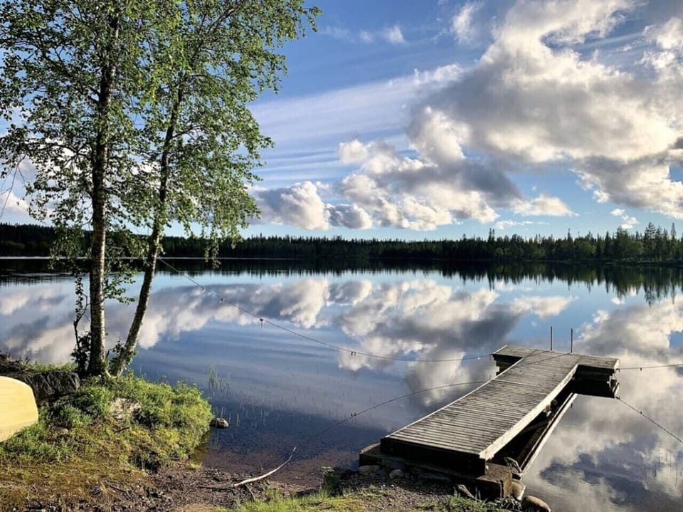 Wooden pier reaching out into the calm lake.