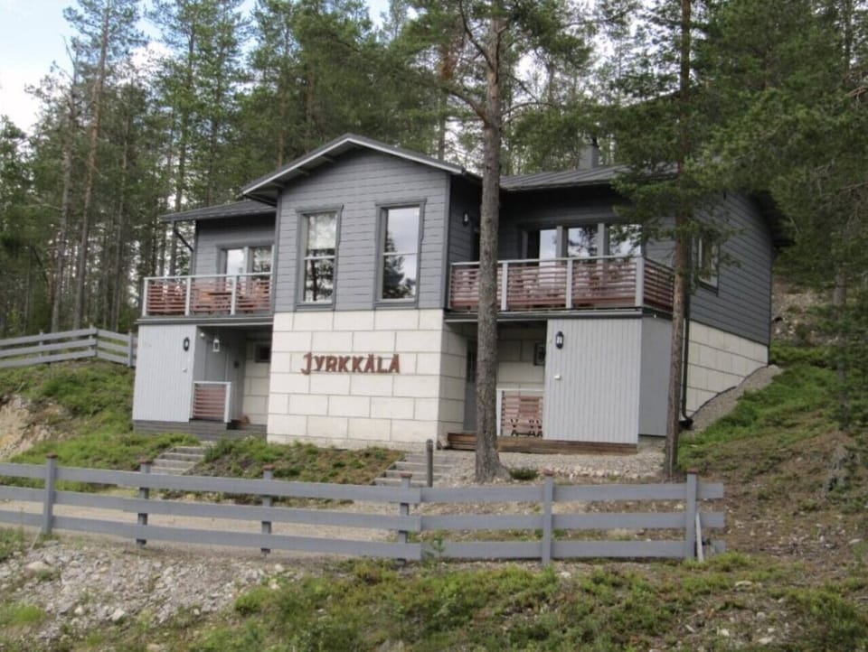 Exterior of the Jyrkkälä building showing the entrance and private balcony.