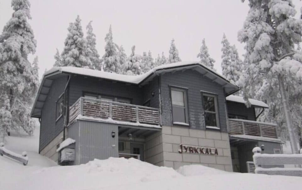 Winter view of the property surrounded by snow-covered trees.