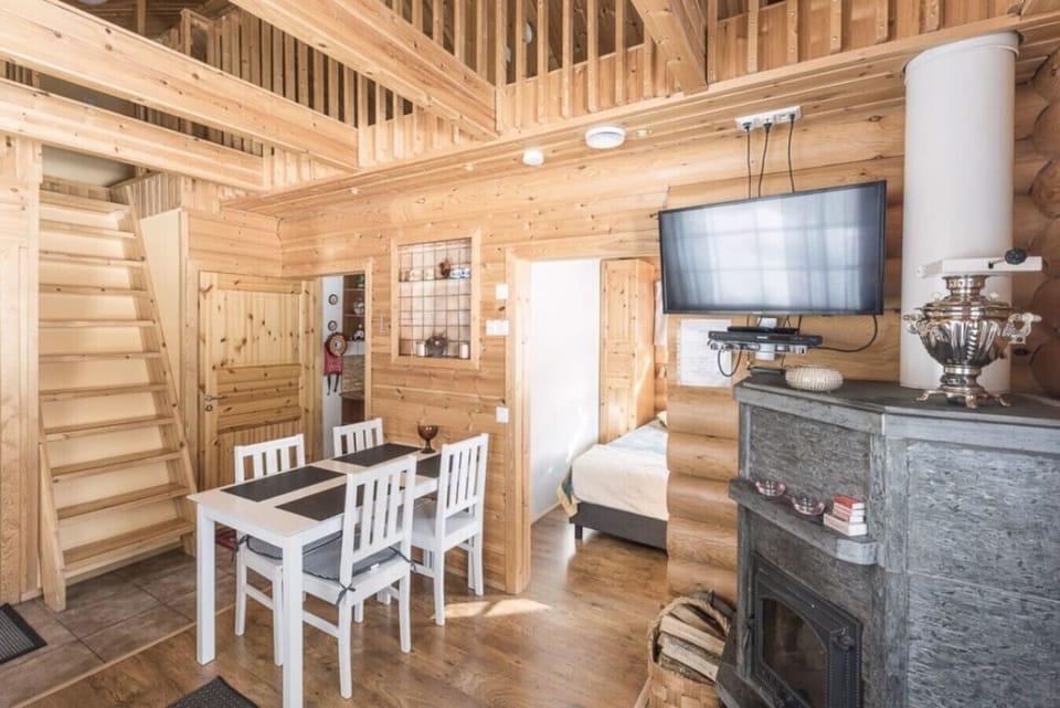 Interior view showing the staircase leading to the loft, with a cozy living area below.