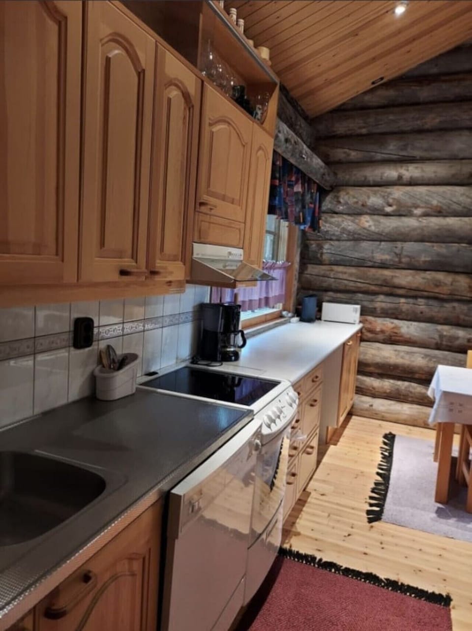 Kitchen with sink, electric stove and coffee maker