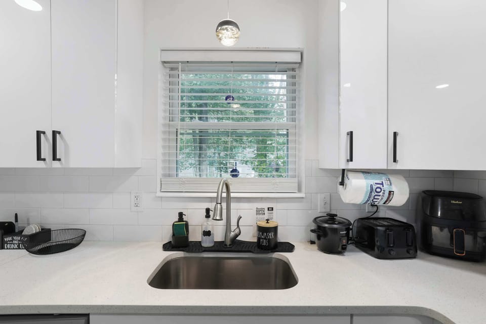 Sleek countertops and a bright window nook — small comforts that make the kitchen a pleasure to use.