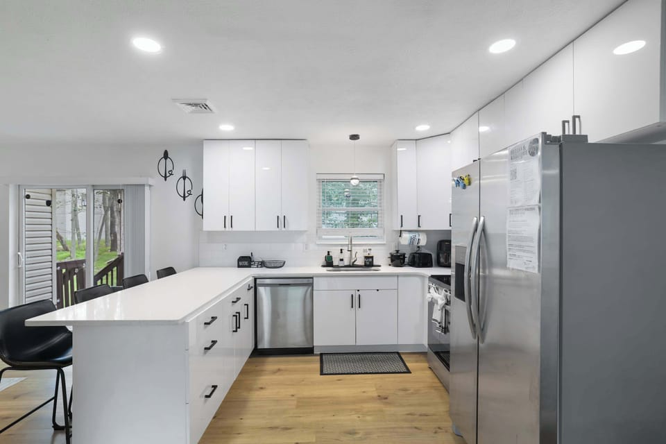 A chef's dream — stainless steel appliances, white cabinetry, and all the space you need to cook up something great.