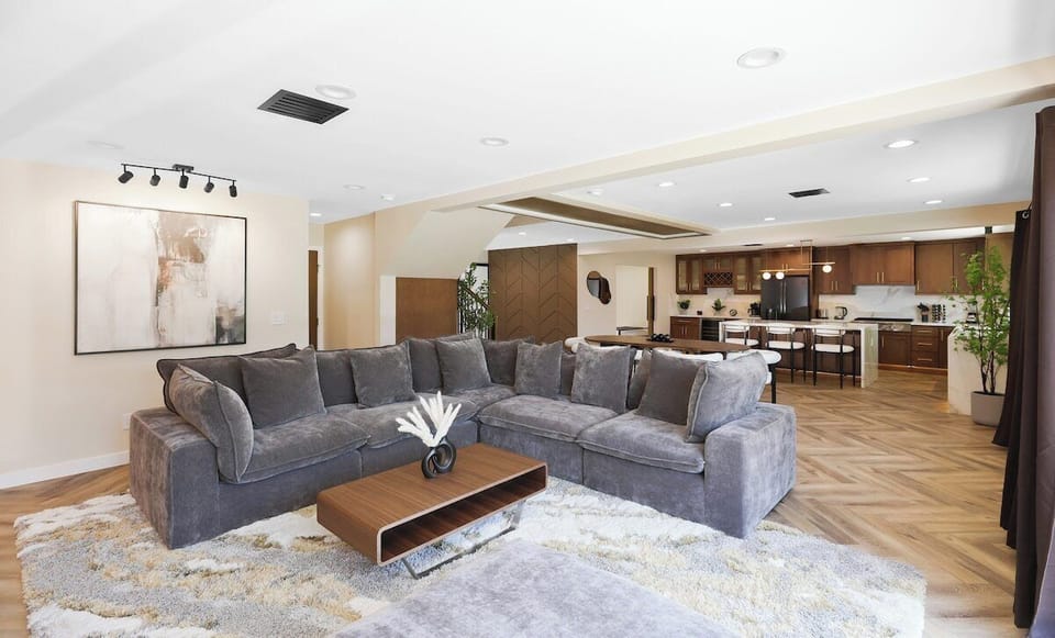 Open-concept living space featuring living room, expansive kitchen area and dining space. 