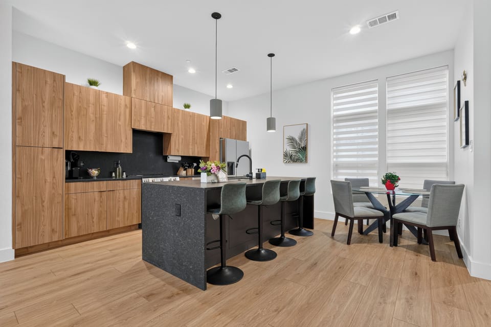 Modern kitchen with island seating and a bright, cozy dining nook