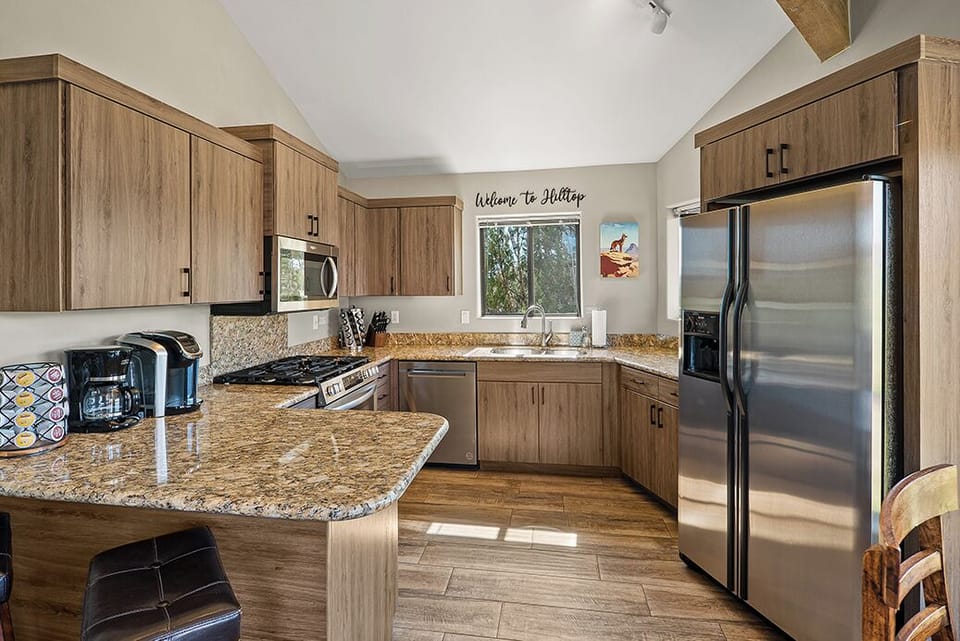[Kitchen] A fully equipped chef's kitchen featuring ample space to move around as you cook.