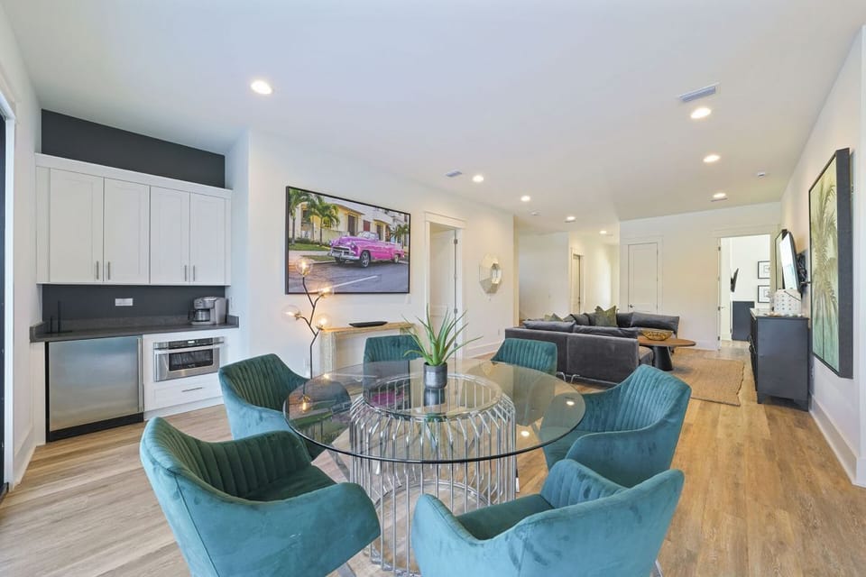 Convenient Ground-Level Kitchenette: Features a mini-fridge, microwave, sink, and coffee bar right next to the outdoor pool entrance.