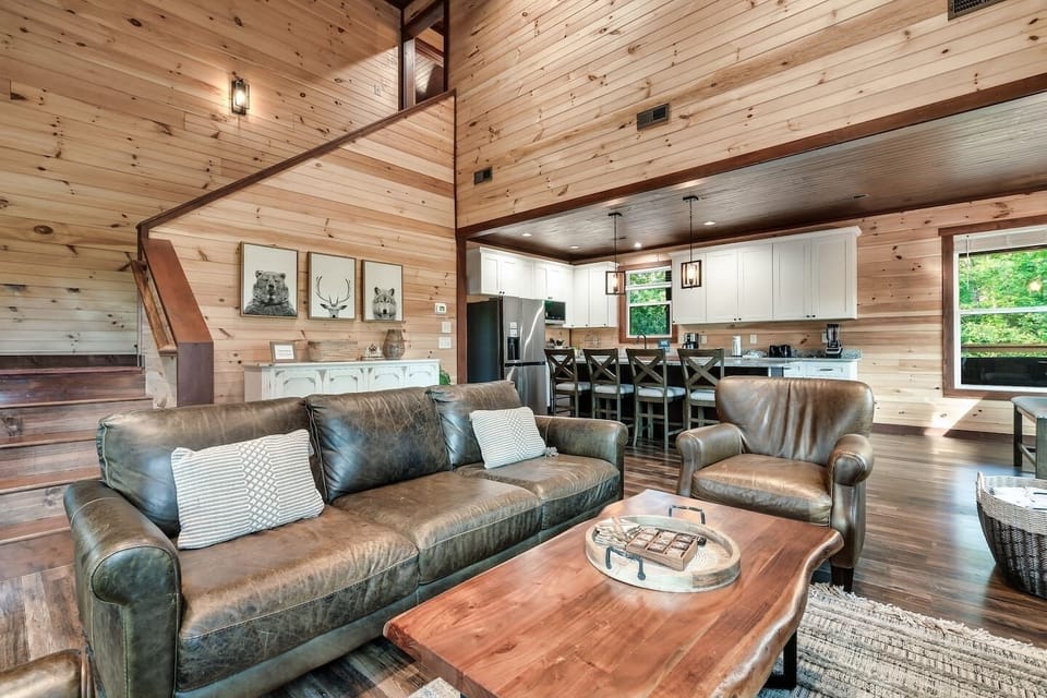 Living Room: Spacious open flow plan with large windows, rustic charm, inviting remote controlled fireplace setting the right ambiance!