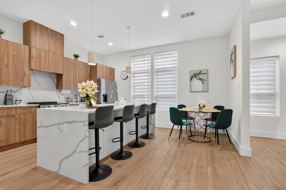 Bright modern kitchen with waterfall island and cozy dining nook