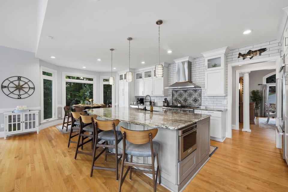 A generous kitchen island offers seating for four, with plenty of prep space and a bright, open setup for cooking and casual meals.