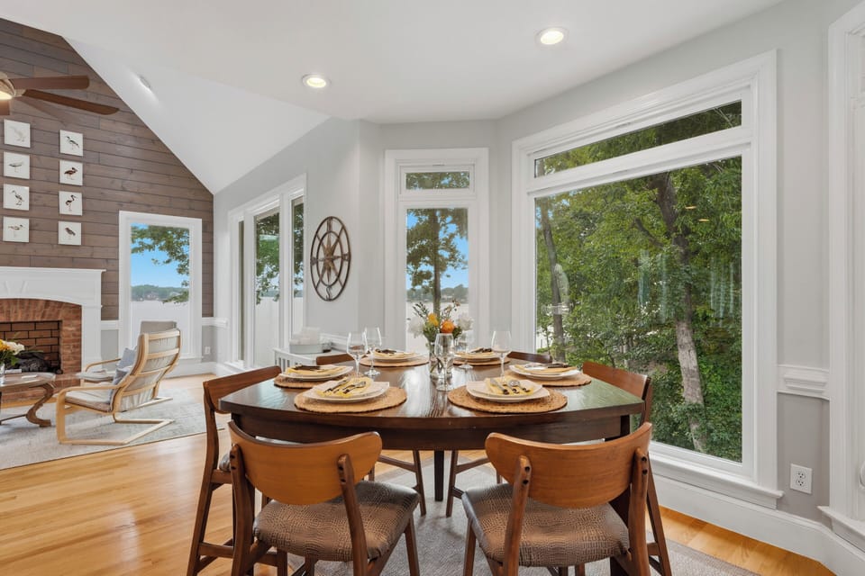 A sunny breakfast nook sits beside the kitchen, offering a welcoming spot for casual meals with leafy views through oversized windows.
