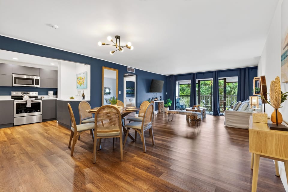 Airy dining area connects the sleek kitchen and inviting living room.