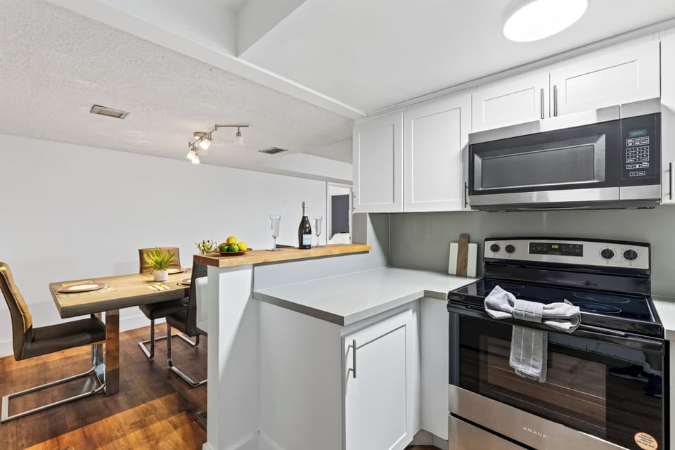 A streamlined kitchen keeps meal prep simple, with full-size appliances, generous cabinet storage, and the dining area just steps away.