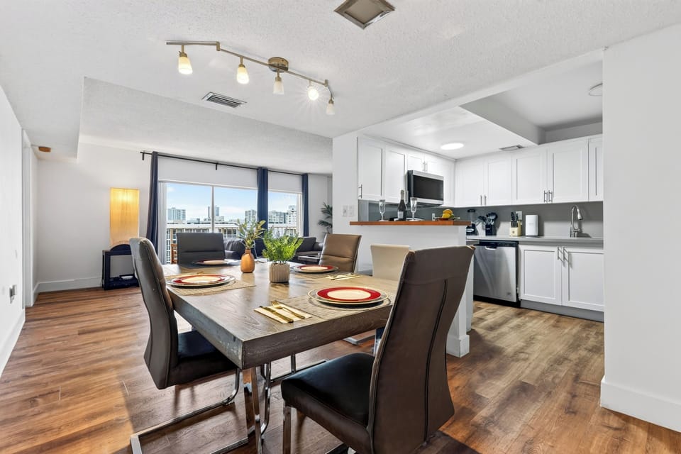 A spacious dining area sits between the modern kitchen and living room, creating a natural hub for meals and conversation.