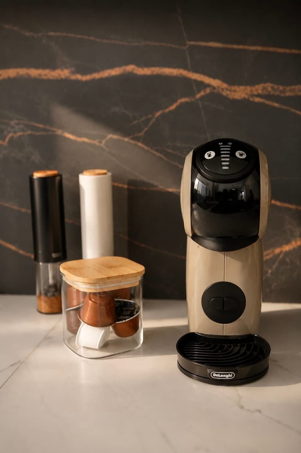 A coffee machine and accessories arranged on the kitchen counter.