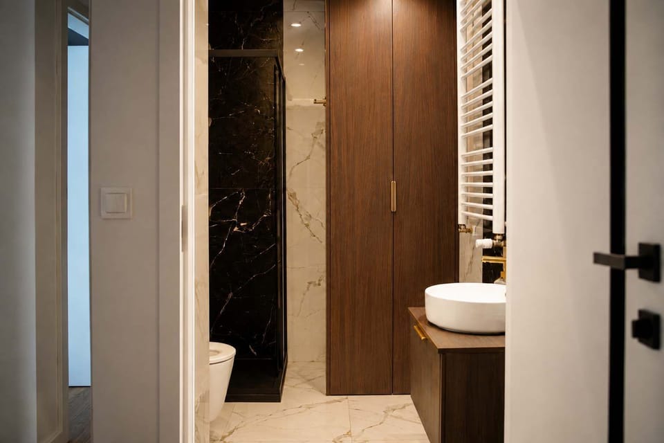 A bathroom with a shower, toilet, and dark wooden cabinetry.