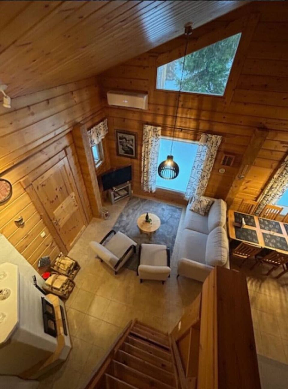 View over the living room from the loft, with comfortable seating.