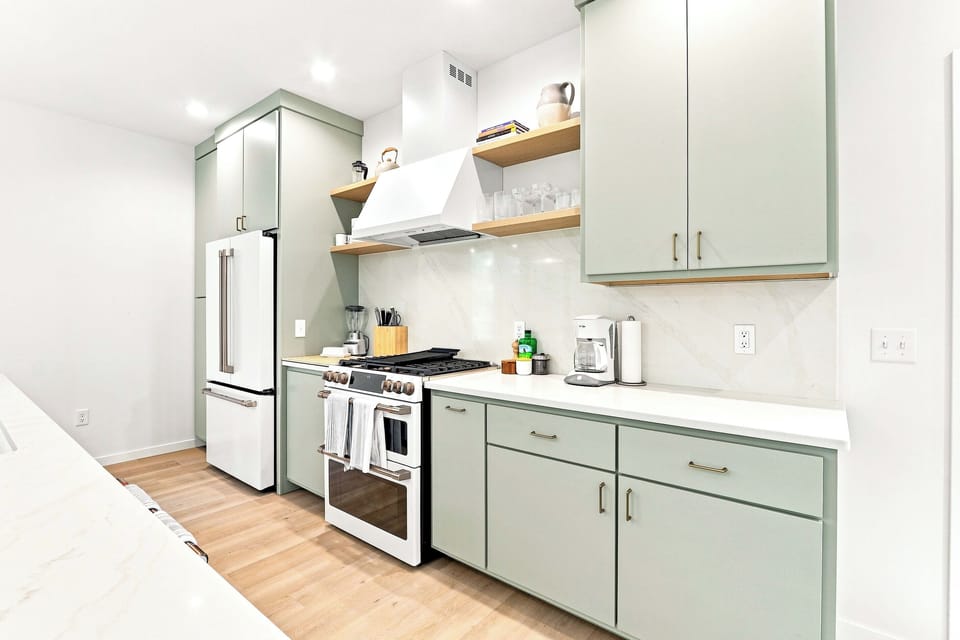 Indulge your inner culinary artist in a beautiful, light-filled space designed for effortless meal preparation. This thoughtfully curated kitchen balances sleek modern details with high-end tools to elevate every meal of your vacation.