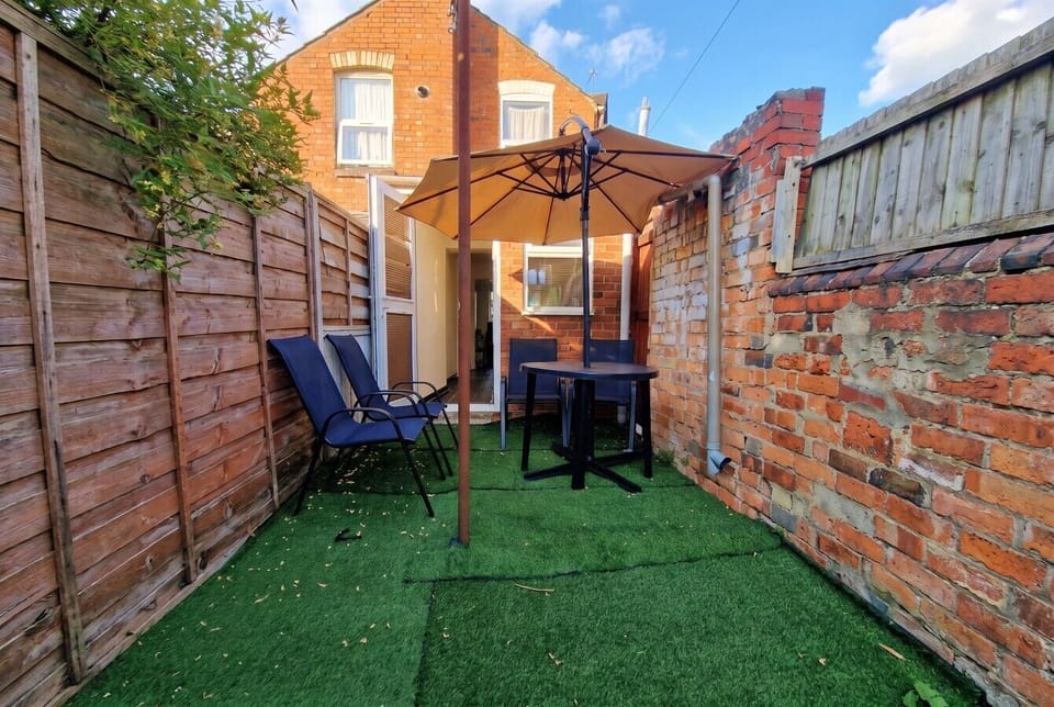 Sunny private courtyard with seating and parasol for relaxed alfresco moments