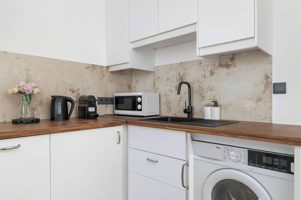 The sleek design of the kitchenette blending seamlessly with the living area.