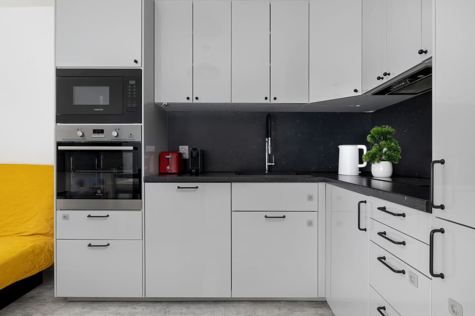 The sleek design of the kitchenette blending seamlessly with the living area.