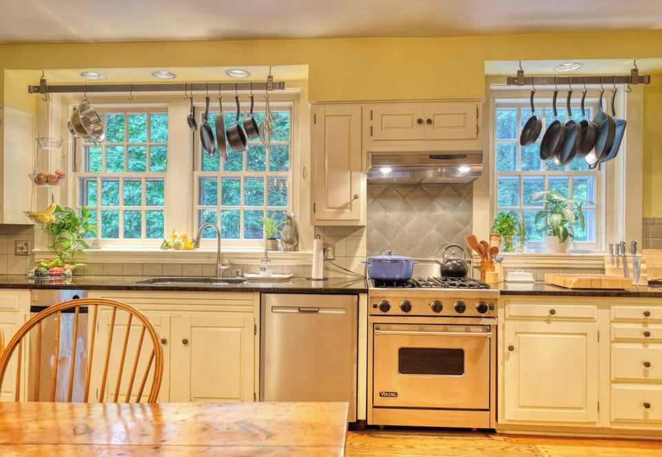 The kitchen is fully equipped with high-quality cookware, utensils, and all the essentials for preparing meals with ease — highlighted by a professional-grade Viking stove for the culinary enthusiast.