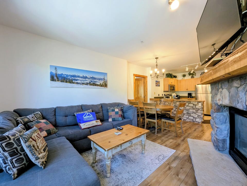 Enjoy the plush sectional by the cozy fireplace.