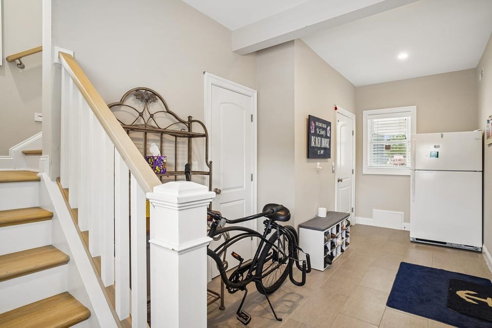 Your entryway welcomes you with everything you need—bike storage, shelving for gear, and a full-size fridge ready to stock your favorites. The bright, open layout with easy stair access sets the tone for a relaxed, practical stay.