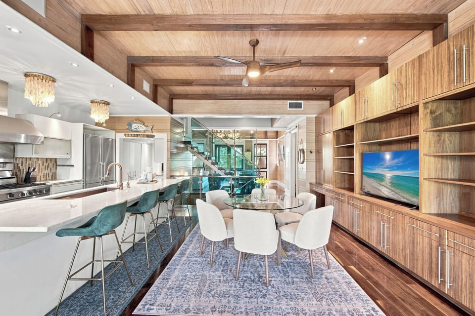 Gather around your spacious kitchen island or settle into the inviting dining nook—this open-concept living space features warm wood finishes, elegant lighting, and all the modern comforts for memorable meals together.