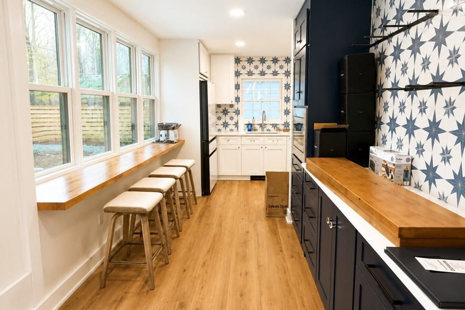Fully stocked kitchen as you walk through the side entrance. Bowl will be on the counter with garage door opener for trash and recycling. Sink on the left has a composter, and second sink on the right has instant hot water for tea.