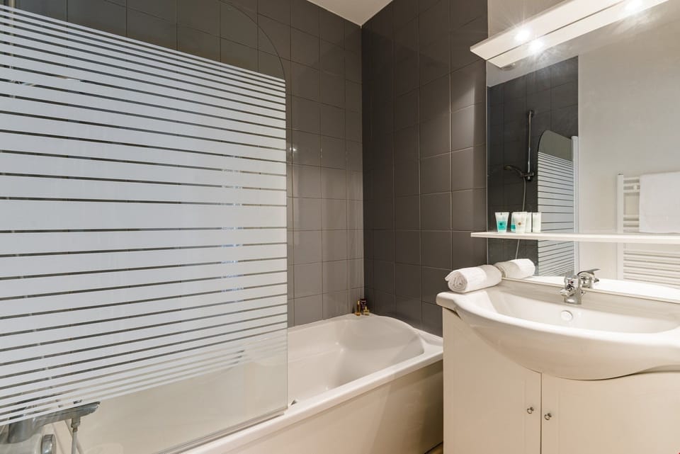 Get ready for the day in the modern and bright bathroom.