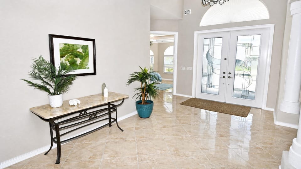Bright and welcoming entrance foyer at Villa Almare with high ceilings and an open, airy layout.