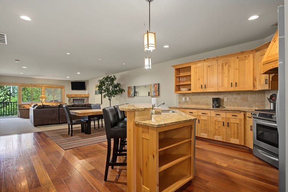 View from the kitchen into the dining and living areas, with access to the private balcony.