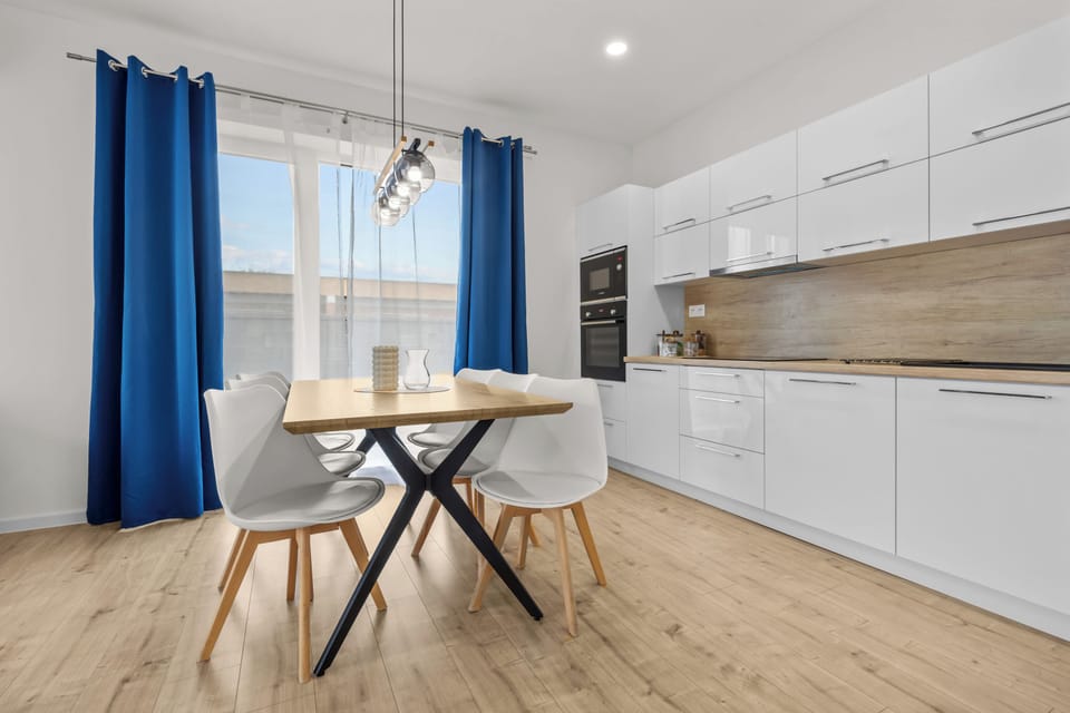 Bright modern kitchen with stylish dining area and natural light