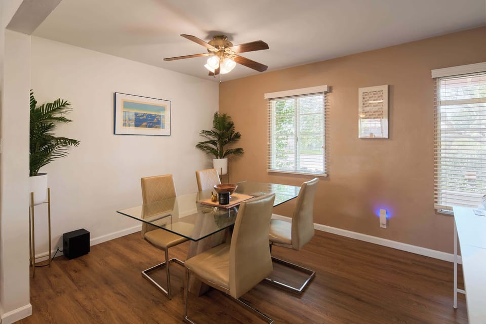 Four can gather around the glass top table in the dining area for a long, unhurried dinner, the warm terracotta wall and soft fan light carrying the evening past dessert.