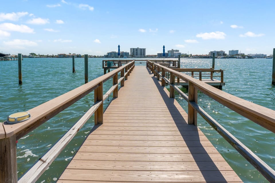 Coral Resort's private dock reaches out over the Intracoastal — perfect for casting a line, watching dolphins and boats pass, or simply walking out over the water at sunrise. Guest access included.