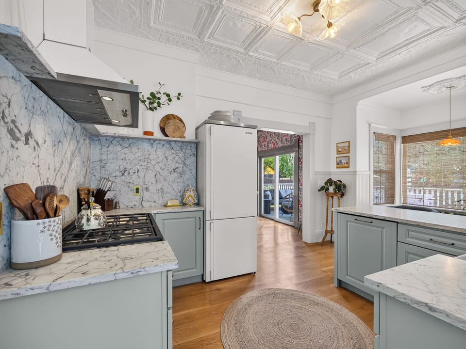 A chef's dream with modern appliances and elegant finishes designed for both functionality and style. The kitchen seamlessly connects to dining and living spaces, creating an open concept perfect for gathering. Spacious countertops provide ample preparation space, while quality cabinetry and fixtures offer convenience.